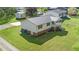 Aerial view of the house showcasing its metal roof, well-maintained lawn, and backyard shed at 1017 S Second Ave, Siler City, NC 27344