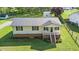 Charming single-story home showcasing its brick foundation, metal roof, and a well-manicured lawn at 1017 S Second Ave, Siler City, NC 27344