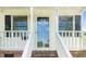Inviting front entrance features a glass storm door, sidelight windows, and traditional trim at 1017 S Second Ave, Siler City, NC 27344