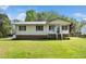 Charming single-story home with brick foundation, metal roof, and a well-manicured lawn at 1017 S Second Ave, Siler City, NC 27344
