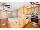 Kitchen area featuring a breakfast bar with an opening to a living room and large window at 1017 S Second Ave, Siler City, NC 27344