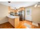 Well-lit kitchen with stainless steel appliances, a breakfast bar and wooden cabinets at 1017 S Second Ave, Siler City, NC 27344