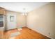 View of kitchen area featuring an entry door, hardwood floors and neutral wall paint at 1017 S Second Ave, Siler City, NC 27344
