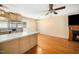 Cozy kitchen featuring stainless steel refrigerator and a breakfast bar overlooking the living area and fireplace at 1017 S Second Ave, Siler City, NC 27344