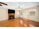 Cozy living room with hardwood floors, a fireplace, and natural light from the windows at 1017 S Second Ave, Siler City, NC 27344