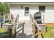 Exterior ramp leading to the back door, accompanied by a grill and trash cans on the wooden deck at 1017 S Second Ave, Siler City, NC 27344