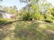 Expansive backyard featuring lush green space and a wooden deck off the house, perfect for outdoor relaxation at 103 Wesker Cir, Durham, NC 27703