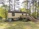 Backyard with a deck and stairs leading to the lawn at 103 Wesker Cir, Durham, NC 27703