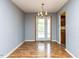 Bright dining area featuring wood floors and a door leading to the outdoors at 103 Wesker Cir, Durham, NC 27703