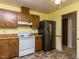 Clean kitchen with cabinets, appliances, and tile flooring at 103 Wesker Cir, Durham, NC 27703