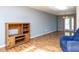 Spacious living room with wood-look floors, natural light, and functional built-in shelving at 103 Wesker Cir, Durham, NC 27703