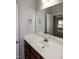 Bathroom featuring vanity with a sink and faucet, paired with a large mirror and a doorway view at 104 Mainline Sta, Morrisville, NC 27560
