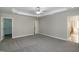 Large bedroom with neutral paint and multiple doorways to closets and bathroom at 104 Mainline Sta, Morrisville, NC 27560
