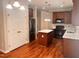 Kitchen featuring wood flooring, stainless steel appliances, and white double door pantry at 104 Mainline Sta, Morrisville, NC 27560