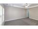 Spacious main bedroom with tray ceiling and windows, featuring neutral carpet and modern fan at 104 Mainline Sta, Morrisville, NC 27560