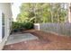 This home's backyard features a small concrete patio and green shrubs at 104 Mainline Sta, Morrisville, NC 27560