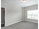 This is a view of a bedroom with light grey walls and large windows at 104 Mainline Sta, Morrisville, NC 27560