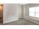 Carpeted bedroom offering a window nook, base trim, and plenty of light at 104 Mainline Sta, Morrisville, NC 27560