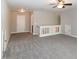 Expansive carpeted bonus room with ceiling fan, multiple entryways, and neutral decor at 104 Mainline Sta, Morrisville, NC 27560