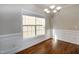 Dining room featuring a large window with bright lighting, hardwood floors, and neutral walls at 104 Mainline Sta, Morrisville, NC 27560
