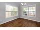 Sunlit dining area with hardwood floors, large windows, and neutral paint for versatility at 104 Mainline Sta, Morrisville, NC 27560