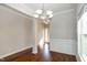 Bright dining room with hardwood floors, crown molding, and a modern chandelier fixture at 104 Mainline Sta, Morrisville, NC 27560