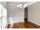 Inviting dining area with hardwood floors, chandelier, and a view of the hallway at 104 Mainline Sta, Morrisville, NC 27560