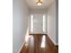 Bright entryway featuring hardwood floors, a white front door, and a classic ceiling light fixture at 104 Mainline Sta, Morrisville, NC 27560