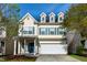 Charming two-story home with a well-manicured lawn, blue shutters and attached two car garage at 104 Mainline Sta, Morrisville, NC 27560