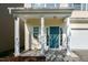 Inviting front porch with classic columns and teal front door at 104 Mainline Sta, Morrisville, NC 27560