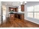 Open kitchen and dining area featuring wood floors, stainless steel appliances, and bright windows at 104 Mainline Sta, Morrisville, NC 27560