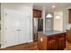 Kitchen island and stainless steel refrigerator with plenty of cabinets and access to storage at 104 Mainline Sta, Morrisville, NC 27560