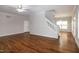 Spacious living room with wood-look floors, white trim, a staircase, and plenty of natural light at 104 Mainline Sta, Morrisville, NC 27560