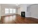 Bright living room featuring a fireplace, large windows, and hardwood floors at 104 Mainline Sta, Morrisville, NC 27560