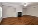 Living room with a cozy fireplace, light walls, white trim and wood-look floors at 104 Mainline Sta, Morrisville, NC 27560