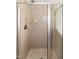 Tiled walk-in shower with glass doors and chrome fixtures at 104 Mainline Sta, Morrisville, NC 27560