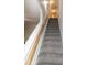 Carpeted staircase with wooden handrail leading to the upper level of the home at 104 Mainline Sta, Morrisville, NC 27560