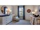 Bright Bedroom with a round mirror, stylish furniture, and soft gray carpet at 105 Sepals Pl, Wendell, NC 27591