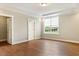Bright bedroom with hardwood floors, trim and a large window offering a view of the backyard at 1073 Fairhaven Dr # 52, Mebane, NC 27302