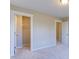 Spacious carpeted bedroom with walk-in closet and doors leading to hallway and other rooms at 1073 Fairhaven Dr # 52, Mebane, NC 27302