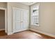Bedroom featuring closet, trim, hardwood floor, and natural light from a large window at 1073 Fairhaven Dr # 52, Mebane, NC 27302