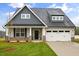 Charming home with a well-manicured lawn, stone accents, and a two-car garage at 1073 Fairhaven Dr # 52, Mebane, NC 27302