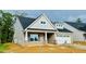 Stylish brick and siding home with an attached two-car garage and inviting entrance at 1073 Fairhaven Dr # 52, Mebane, NC 27302