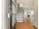 Inviting foyer with a staircase and hardwood floors leads to a cozy living area with a fireplace at 1073 Fairhaven Dr # 52, Mebane, NC 27302