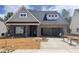 Newly constructed brick home with gray shingles and a two-car garage, under construction at 1073 Fairhaven Dr # 52, Mebane, NC 27302