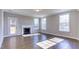 Cozy living room featuring a fireplace, many windows, and an access door to the backyard at 1073 Fairhaven Dr # 52, Mebane, NC 27302