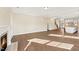 Spacious living room with fireplace, wood floors, and view into the kitchen at 1073 Fairhaven Dr # 52, Mebane, NC 27302