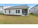 View of the backyard with a screened in porch, lawn and fresh landscaping, new construction at 1116 Ciandra Barn Way, Apex, NC 27523