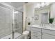 Bathroom with gray tiled shower, white vanity, and neutral walls and flooring at 1116 Ciandra Barn Way, Apex, NC 27523