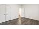 Bedroom with closet and wood-look flooring, providing a serene and stylish space at 1116 Ciandra Barn Way, Apex, NC 27523